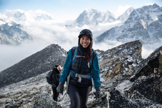 women on mountain with gear